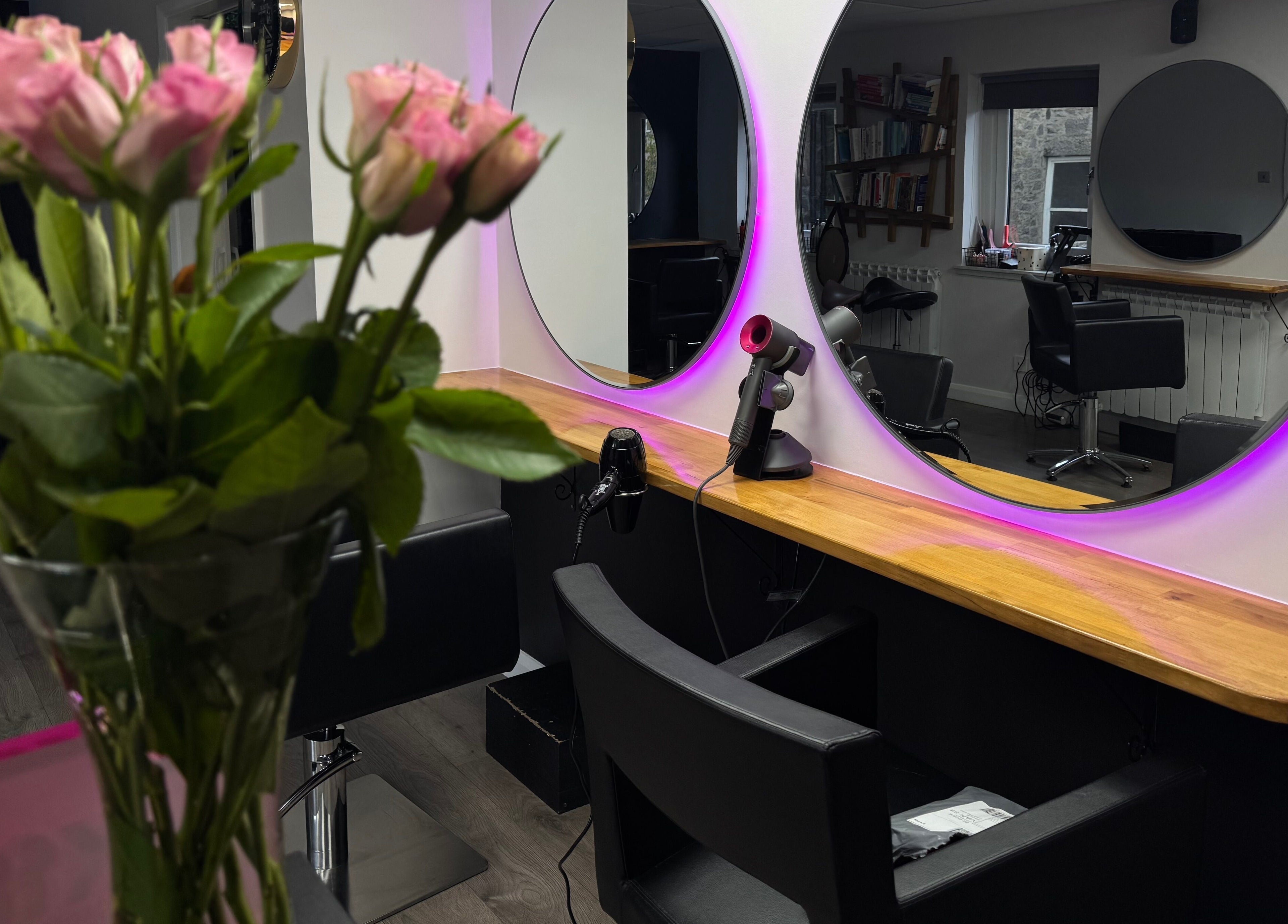 Stylish salon setup at Pimp My Hair, Aberdeen, Scotland, GB with mirrors and pink lighting.