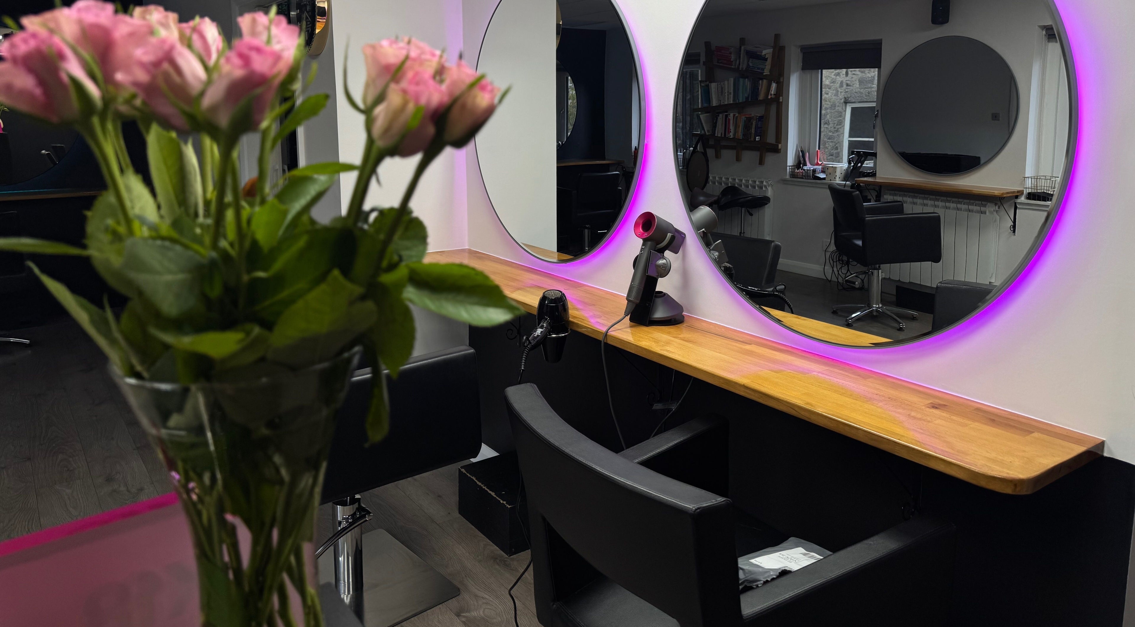 Stylish salon setup at Pimp My Hair, Aberdeen, Scotland, GB with mirrors and pink lighting.
