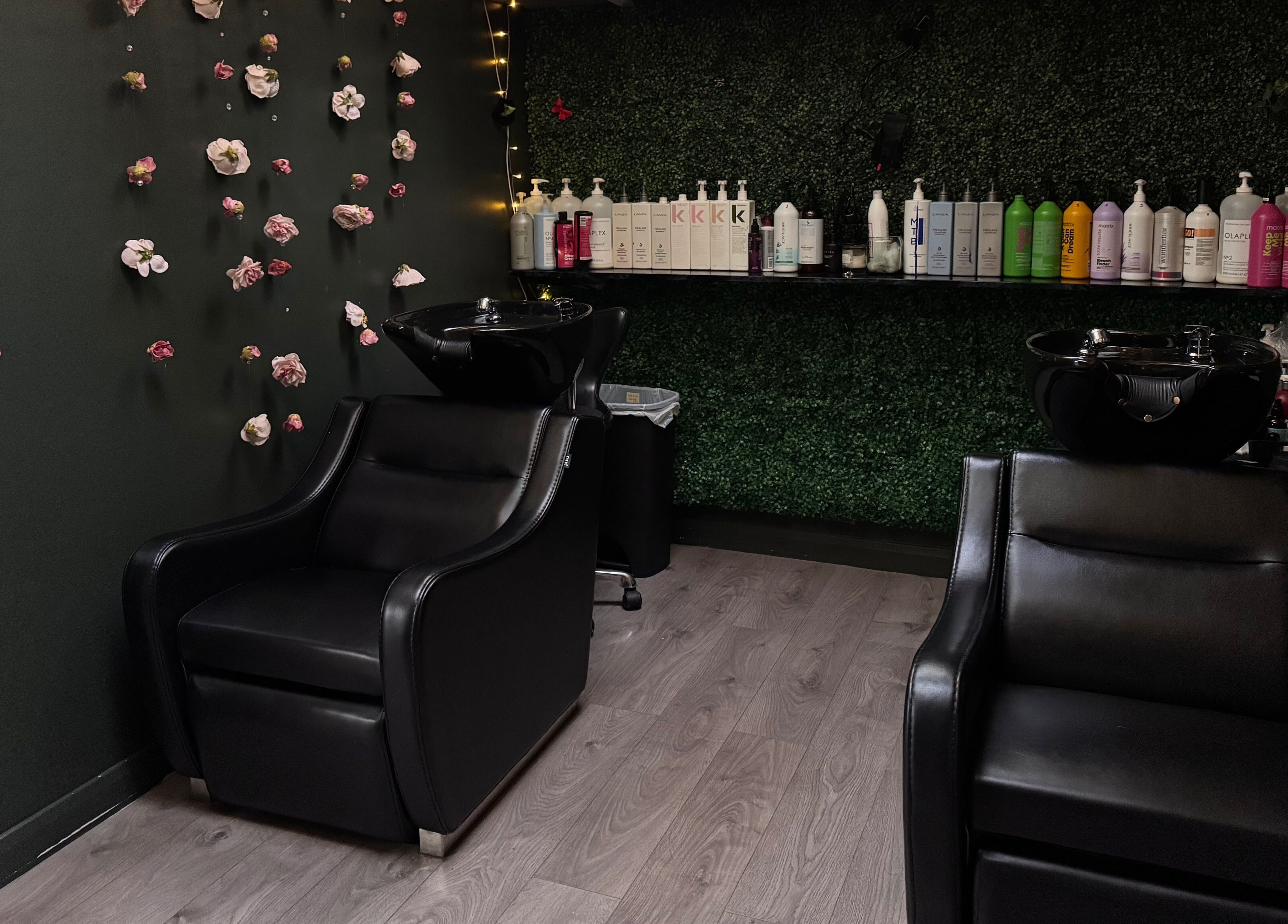 Elegant washing station at Pimp My Hair, Aberdeen, Scotland, GB surrounded by floral decor and product display.