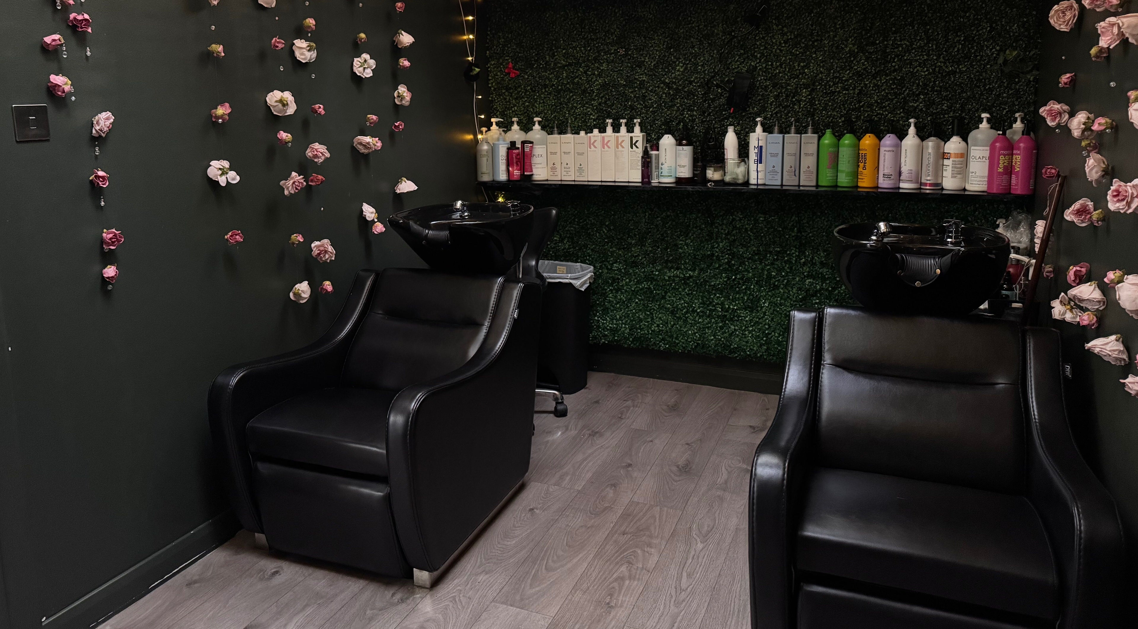 Elegant washing station at Pimp My Hair, Aberdeen, Scotland, GB surrounded by floral decor and product display.