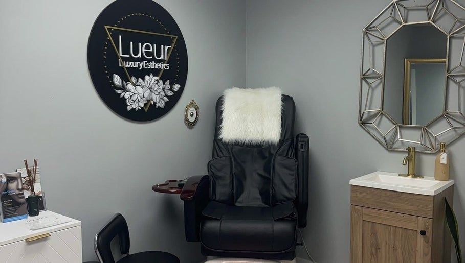 Luxurious treatment chair at Lueur Luxury Esthetics in Naicam, Saskatchewan, CA, alongside stylish decor.
