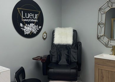 Luxurious treatment chair at Lueur Luxury Esthetics in Naicam, Saskatchewan, CA, alongside stylish decor.