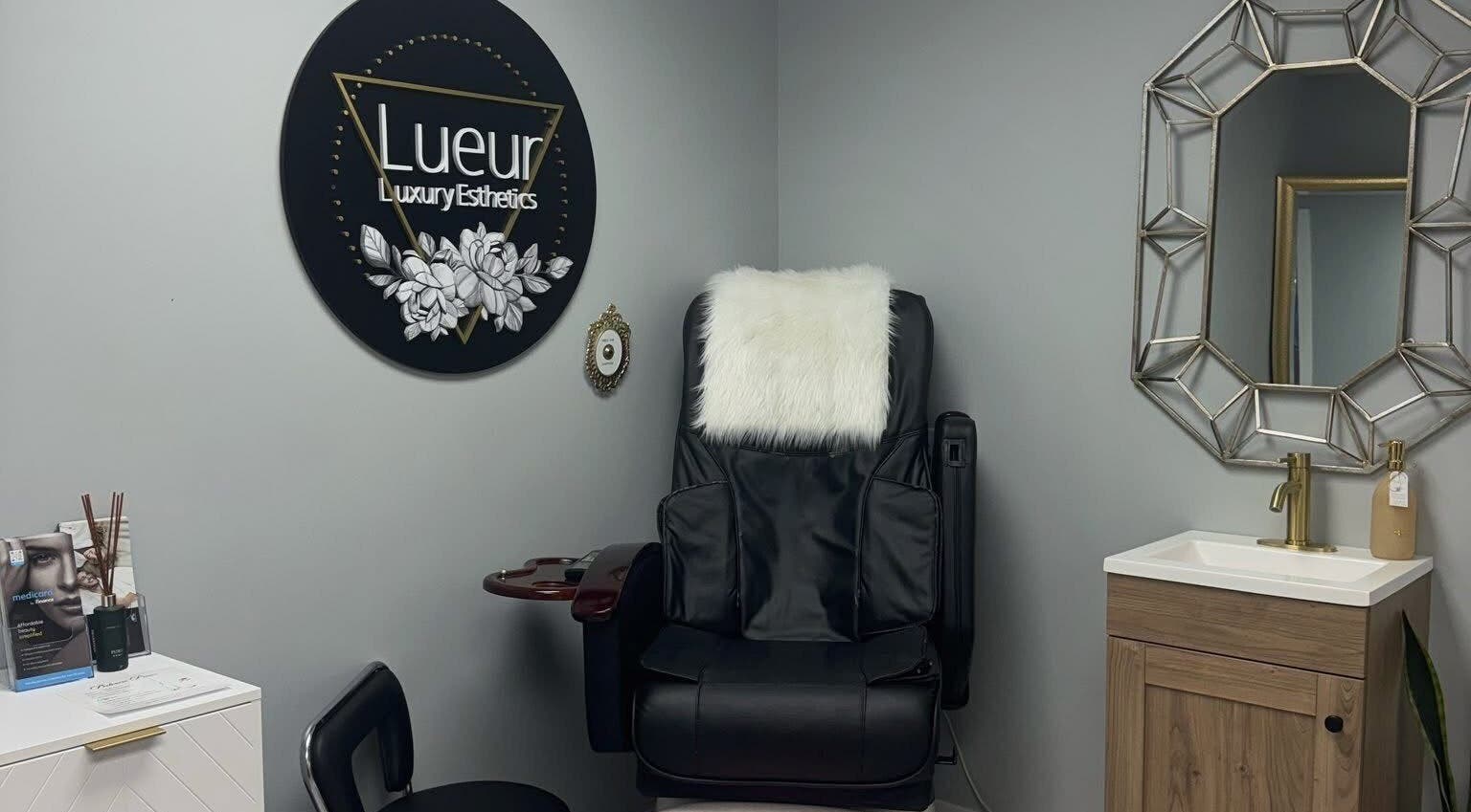 Luxurious treatment chair at Lueur Luxury Esthetics in Naicam, Saskatchewan, CA, alongside stylish decor.