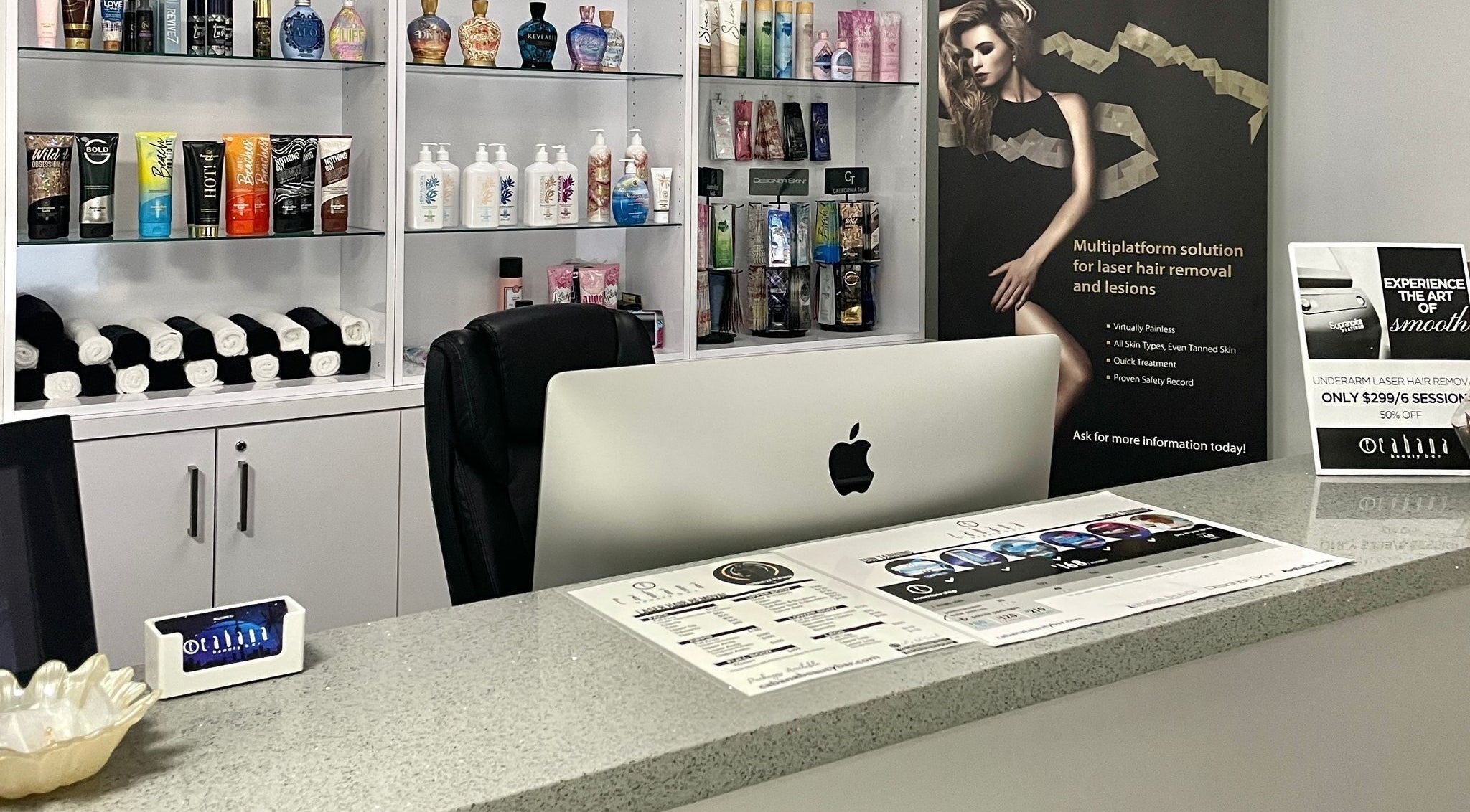 Reception desk at Cabana Tanning & Beauty Bar, Toronto, Ontario, CA showcasing beauty products and promotional displays.