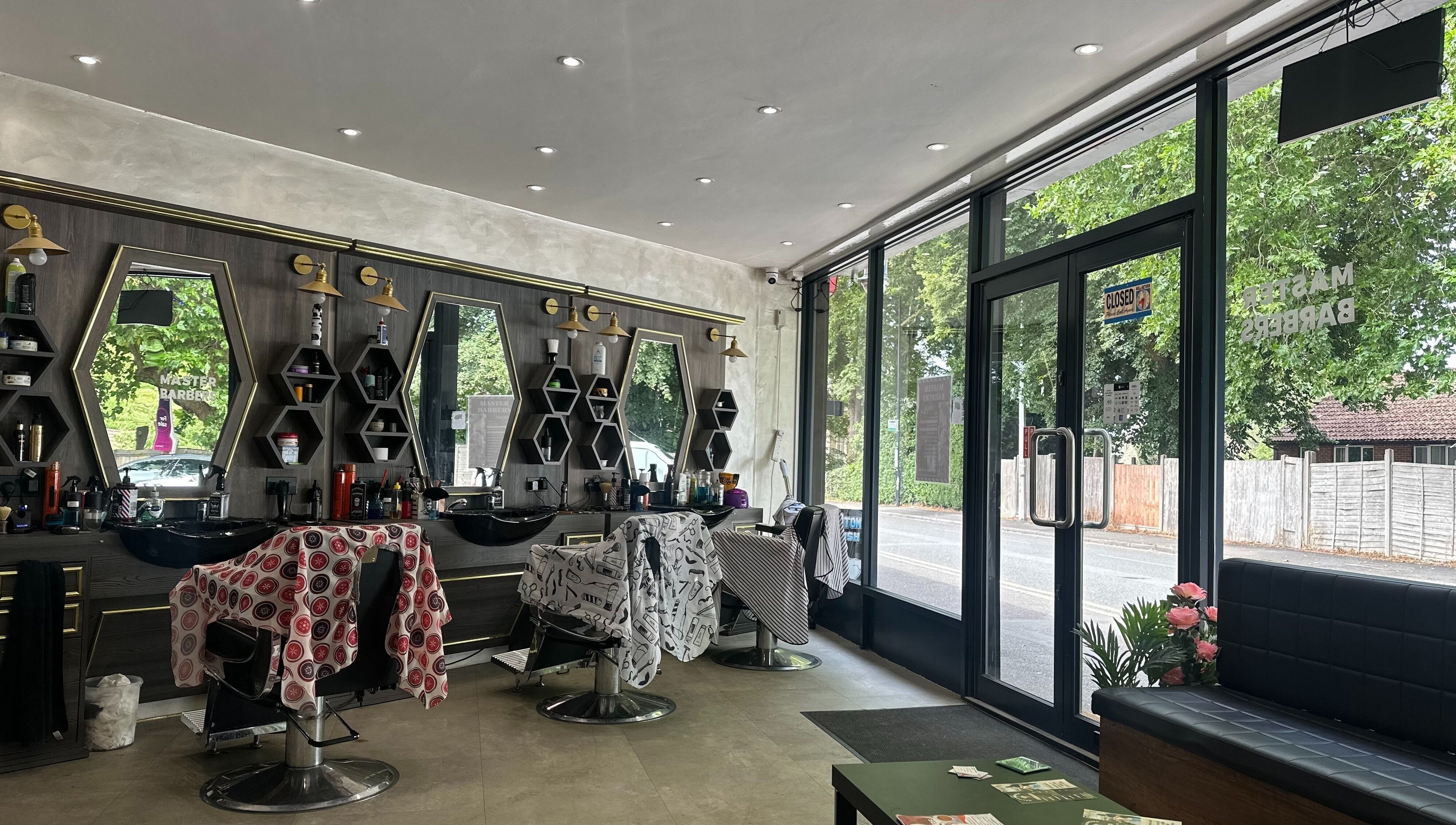 Interior of Master Barbers in Maidenhead, England, GB featuring stylish chairs and mirrors.