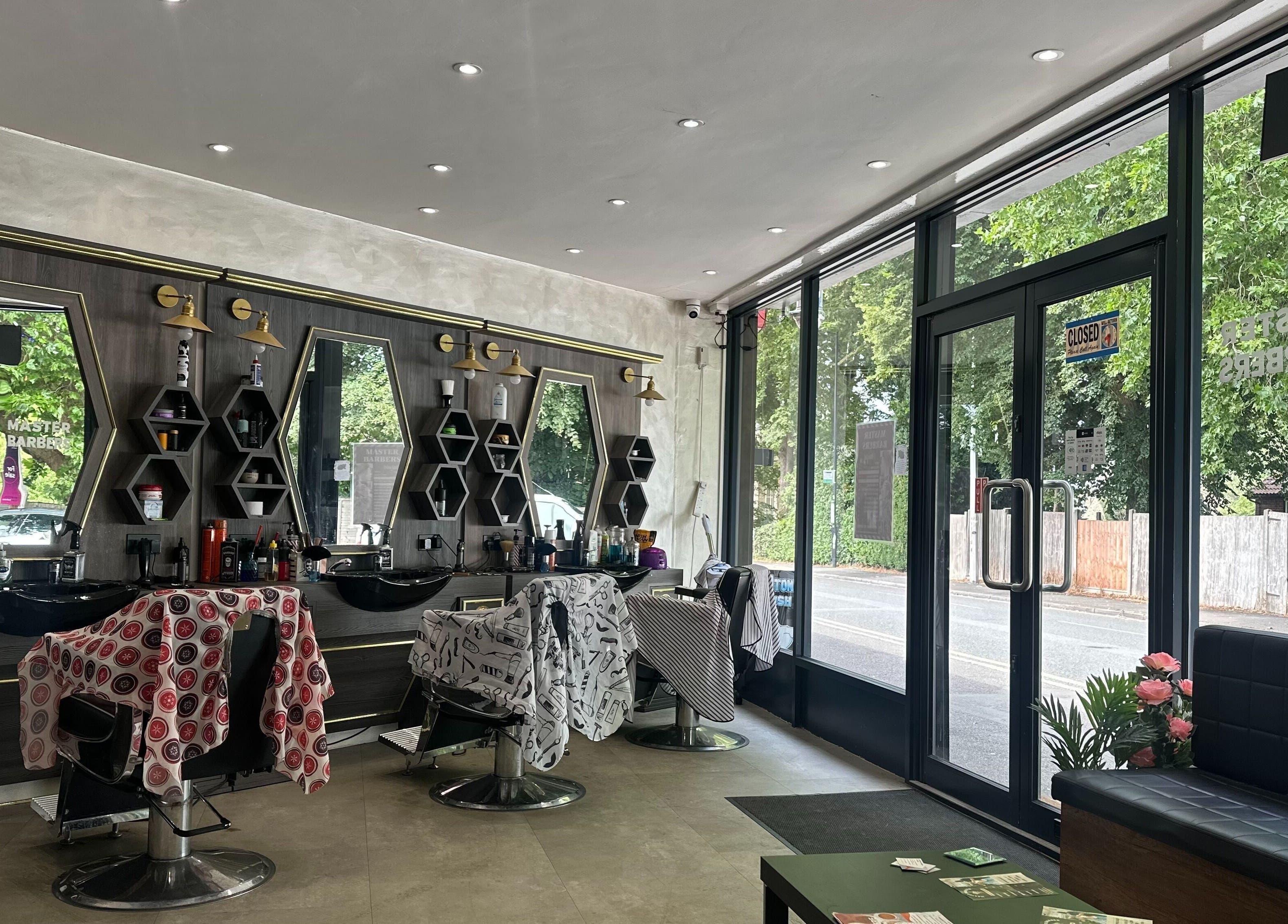 Interior of Master Barbers in Maidenhead, England, GB featuring stylish chairs and mirrors.