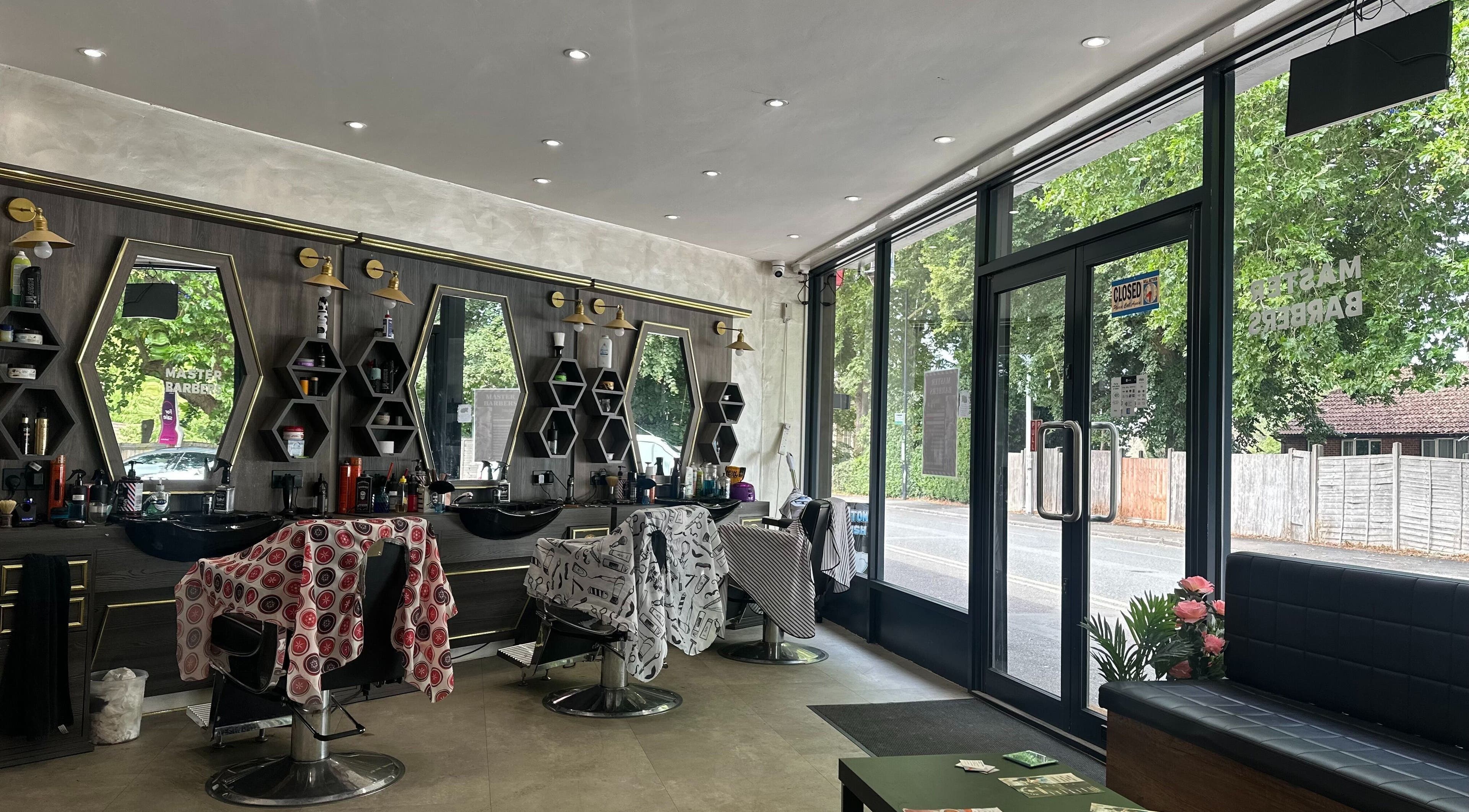 Interior of Master Barbers in Maidenhead, England, GB featuring stylish chairs and mirrors.