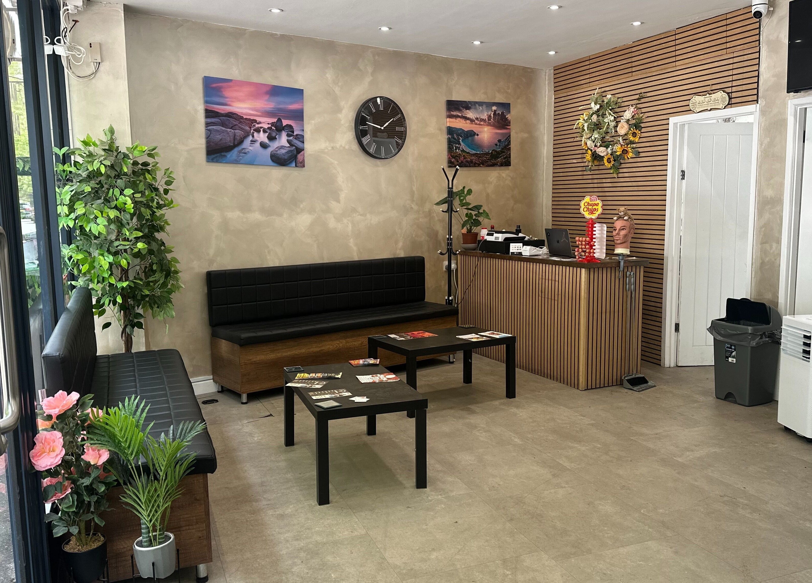Stylish waiting area at Master Barbers, Maidenhead, England, GB, featuring modern decor and seating.