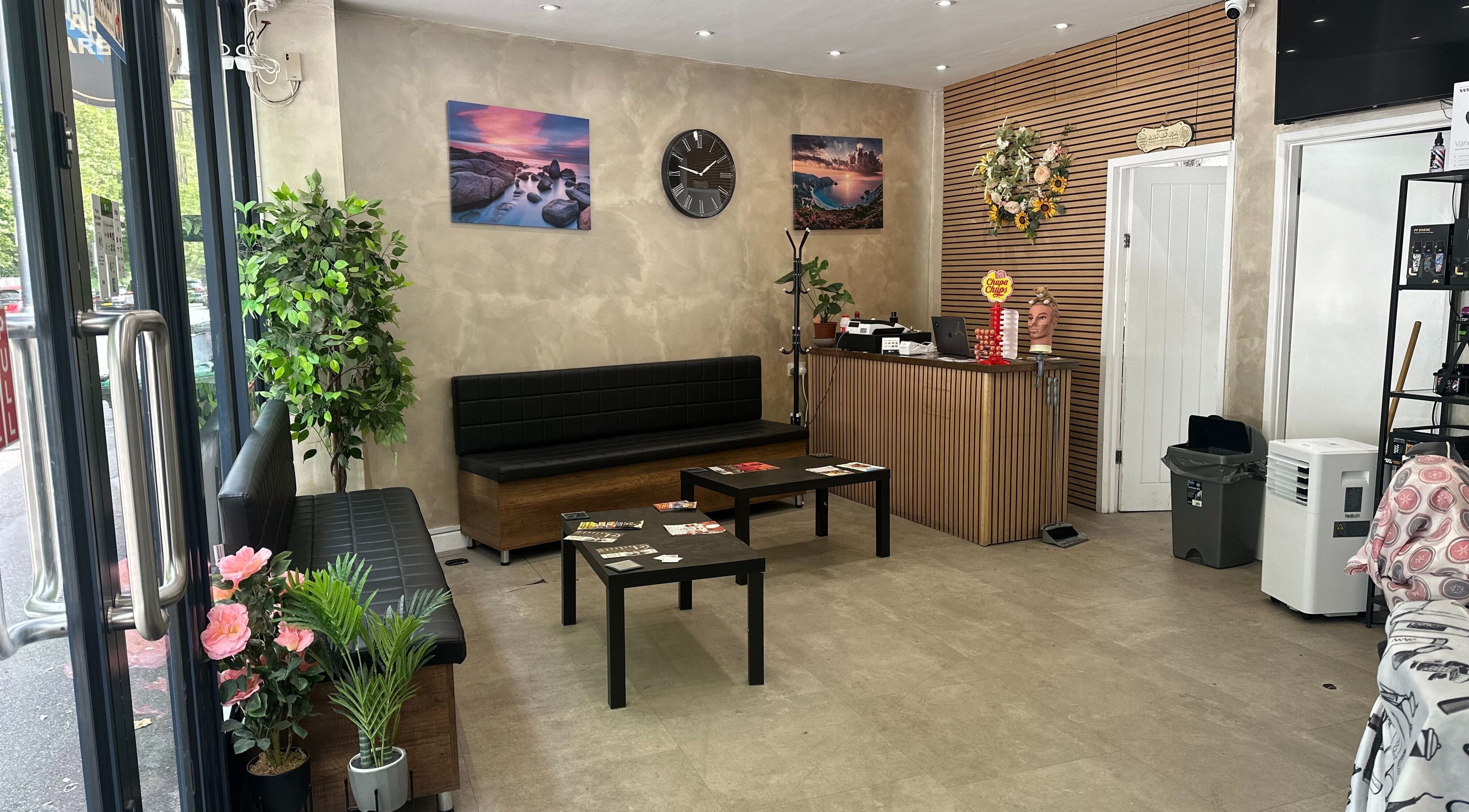 Stylish waiting area at Master Barbers, Maidenhead, England, GB, featuring modern decor and seating.
