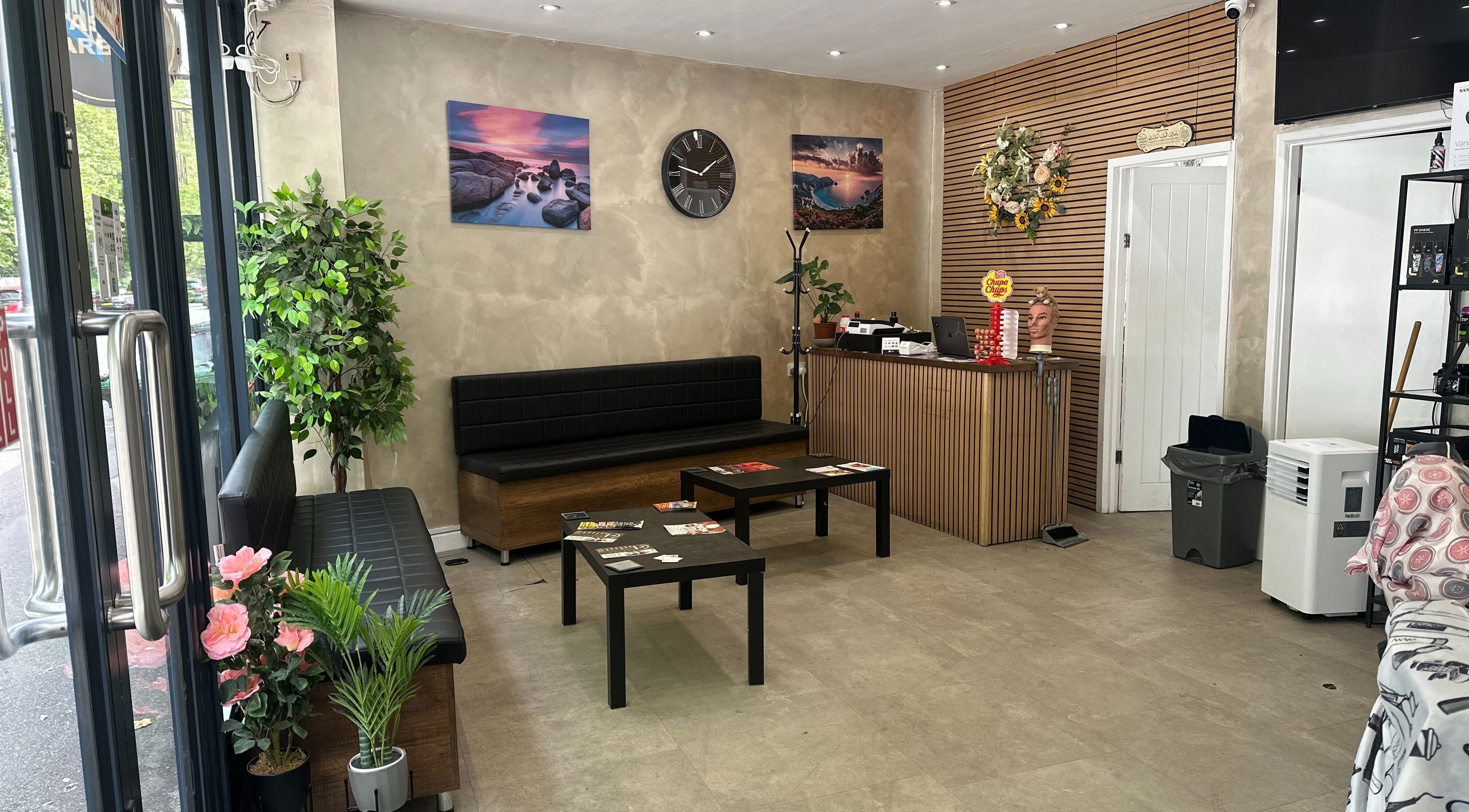Stylish waiting area at Master Barbers, Maidenhead, England, GB, featuring modern decor and seating.