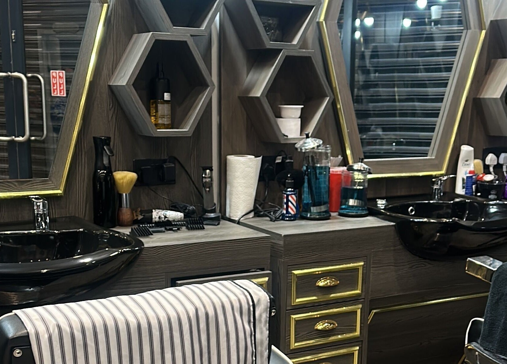Luxurious barber station at Master Barbers, Maidenhead, England, GB with modern hexagonal shelves.