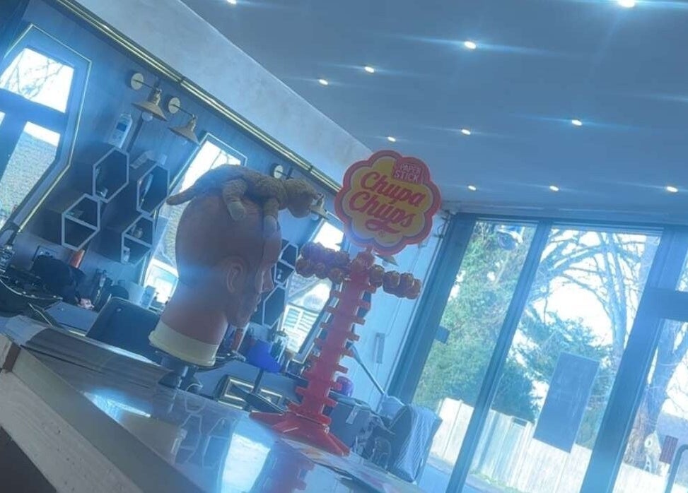 Interior view of Master Barbers, Maidenhead, England, showcasing stylish decor and Chupa Chups display.