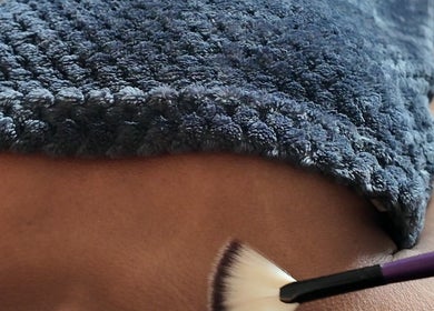 Relaxing spa treatment at Sound, Mind and Bowl in Sidcup, England, GB with a soft brush and warm towel.