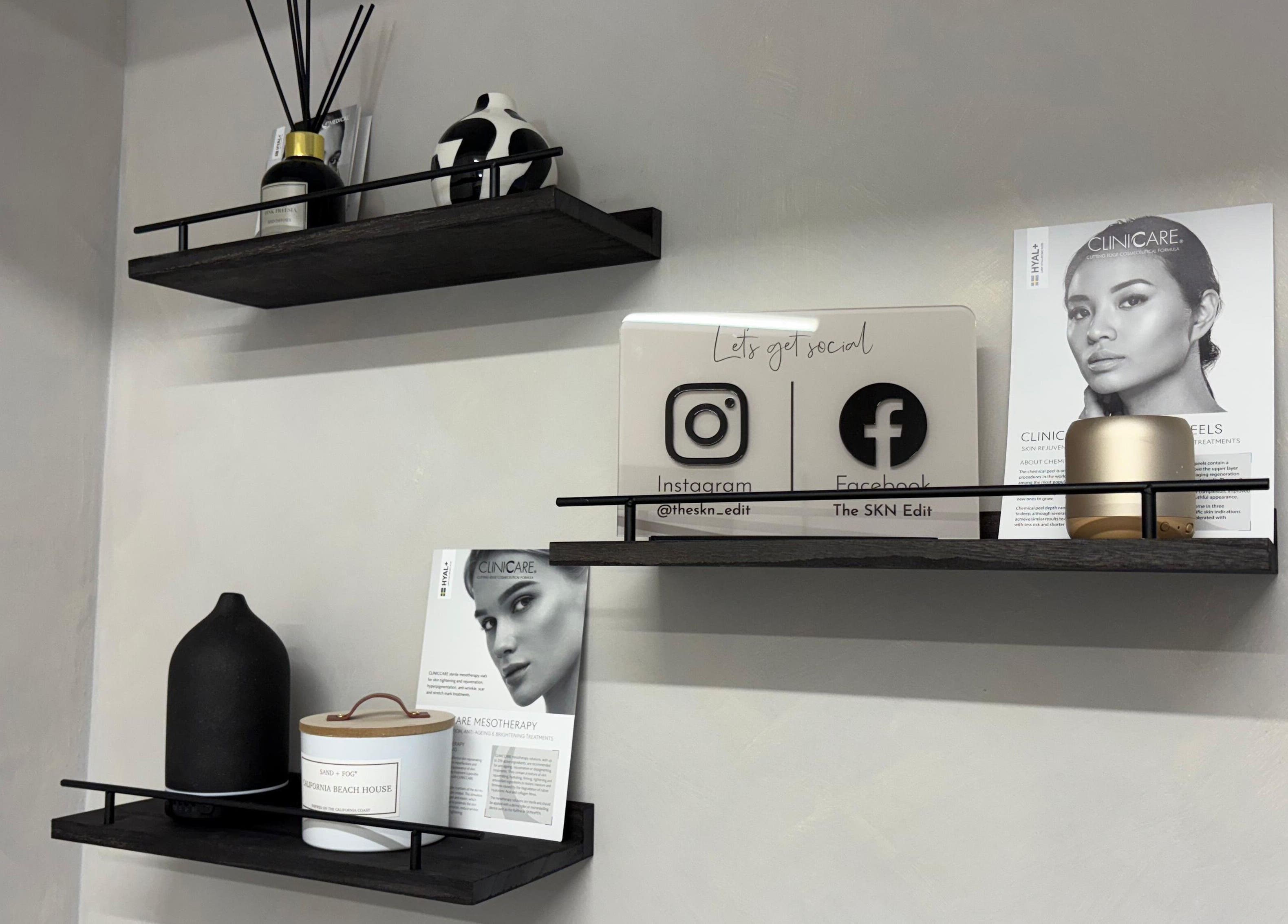 Stylish shelves at The SKN Edit, Winsford, England, GB featuring decor and skincare brochures.