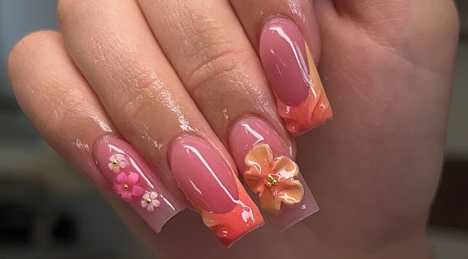 Intricate floral nail art at Clawed By Chey, Breda, Noord-brabant, NL showcasing detailed pink designs.