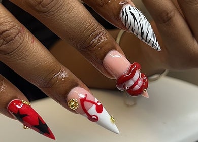 Detailed nail art at Clawed By Chey, Breda, Noord-brabant, NL featuring bold red and zebra patterns.