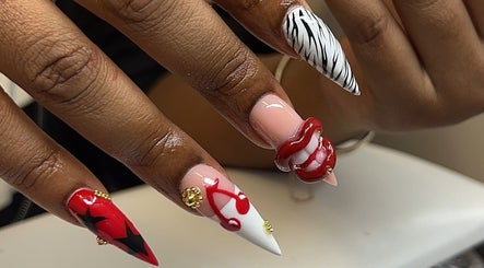 Detailed nail art at Clawed By Chey, Breda, Noord-brabant, NL featuring bold red and zebra patterns.