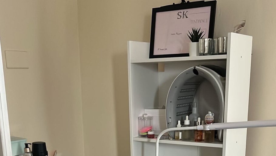NueElleMasion treatment room in London, England, GB, featuring organized beauty products on a sleek shelf.