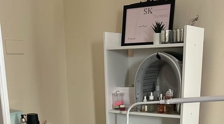 NueElleMasion treatment room in London, England, GB, featuring organized beauty products on a sleek shelf.