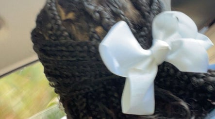 Elegant braided hairstyle with white bow at TTLC, Pembroke, BM.