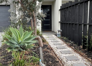 Elegant entrance pathway at The Studio, Melbourne, Victoria, AU with modern landscaping and sleek design.
