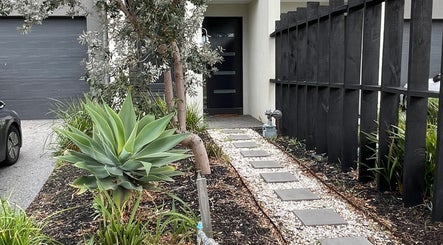 Elegant entrance pathway at The Studio, Melbourne, Victoria, AU with modern landscaping and sleek design.