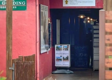 Charming entrance to Sunbird Wellness in Hoedspruit, Limpopo, ZA, featuring vibrant colors and a welcoming vibe.
