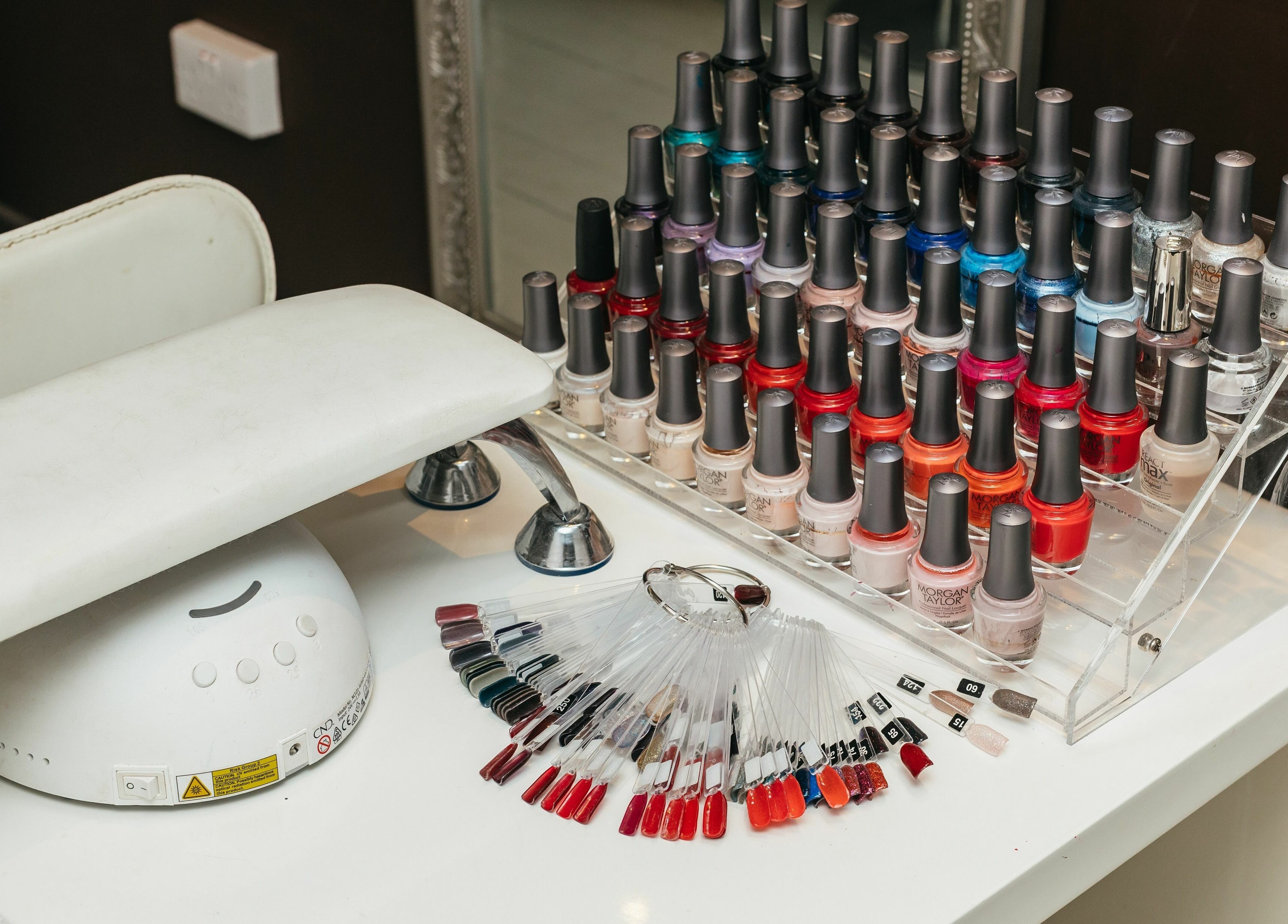 Nail polish collection at Decadence Hair and Beauty in London, England, GB showcasing vibrant colors.