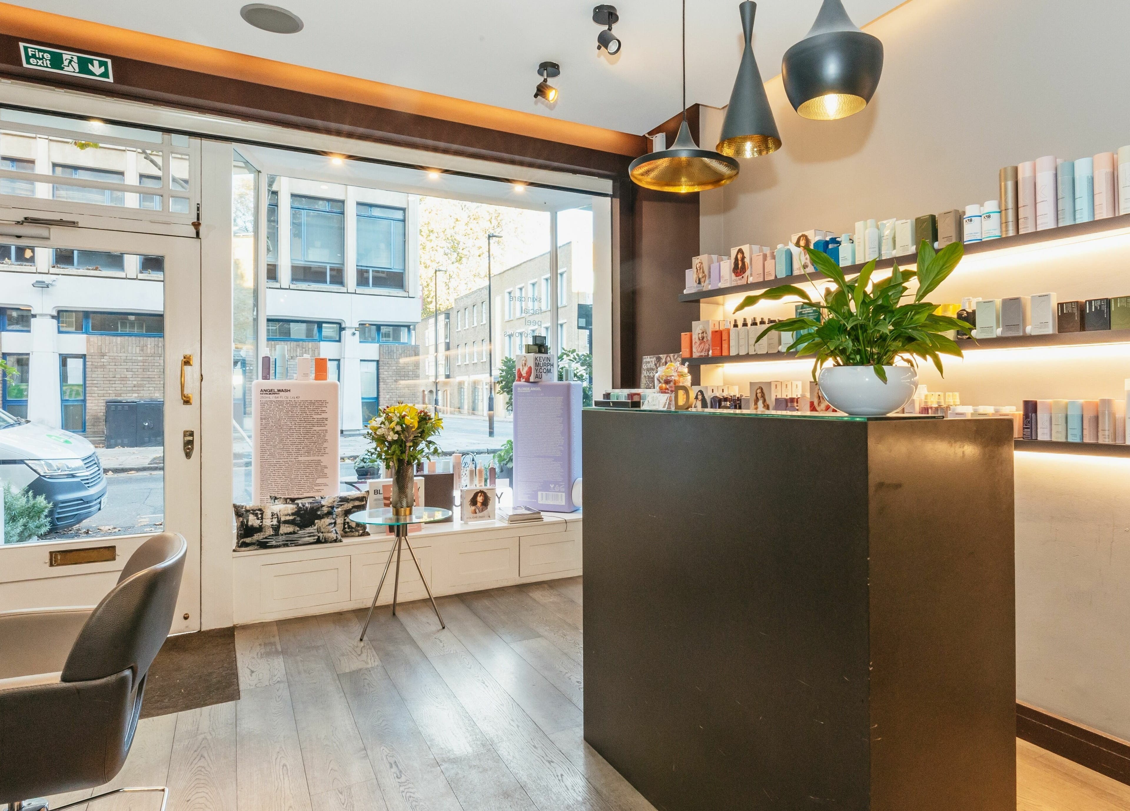 Chic interior of Decadence Hair and Beauty, London, England, GB with elegant shelves and natural light.