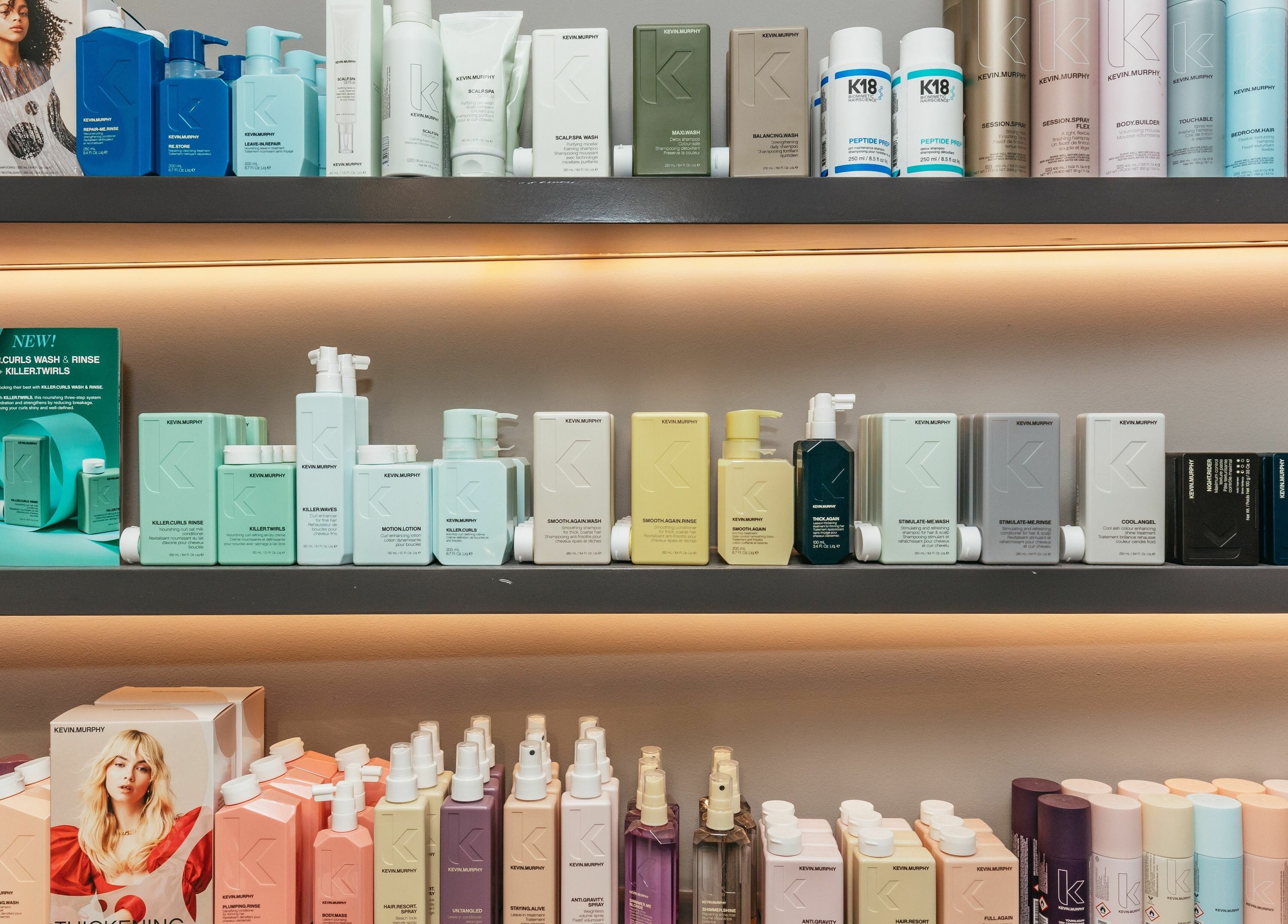 Wide selection of beauty products at Decadence Hair and Beauty, London, England, GB, neatly arranged on shelves.