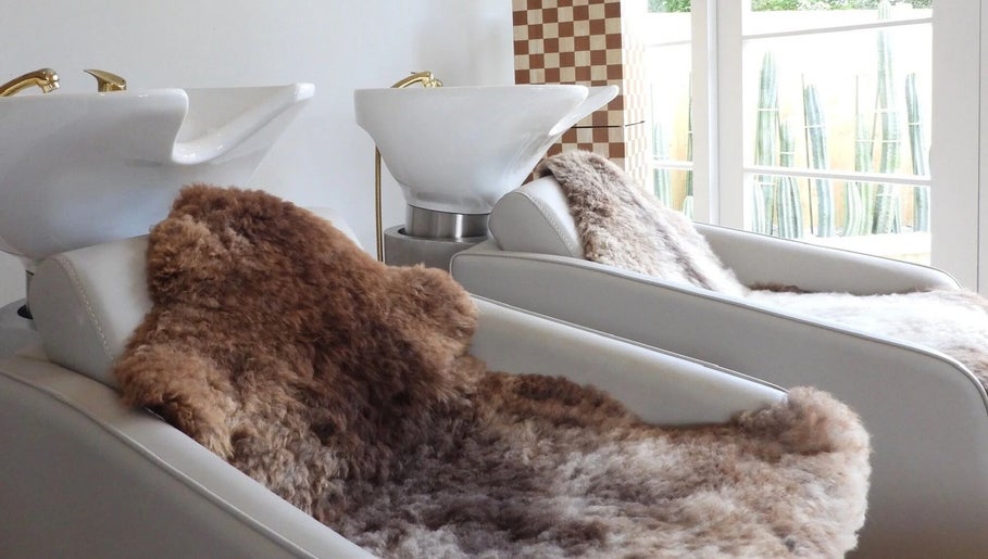Cozy hair washing stations at Chere Cherie in Christchurch, Canterbury Region, NZ with plush fur covers.