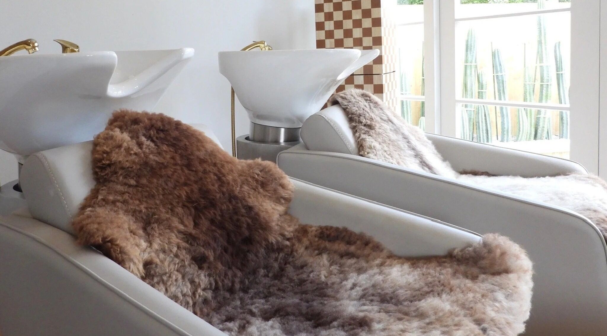 Cozy hair washing stations at Chere Cherie in Christchurch, Canterbury Region, NZ with plush fur covers.