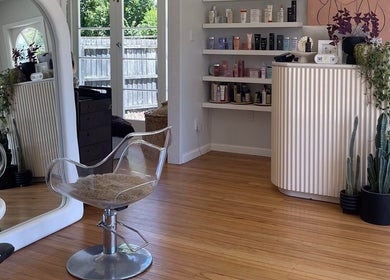 Chere Cherie salon in Christchurch showcases a stylish, modern interior with elegant decor and well-organized shelves.