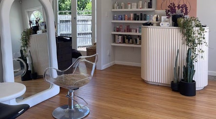 Chere Cherie salon in Christchurch showcases a stylish, modern interior with elegant decor and well-organized shelves.