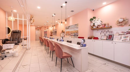 Elegant nail salon interior at Adora Haus, Port Melbourne, Victoria, AU with pink decor and sleek seating.