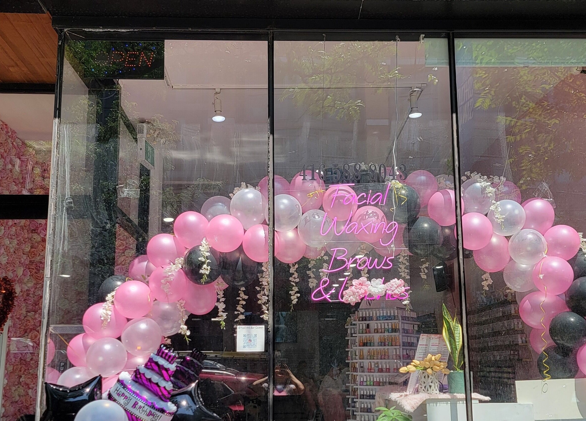 Vibrant balloon arch at Nail Art Bar entrance in Toronto, Ontario, CA welcoming guests.