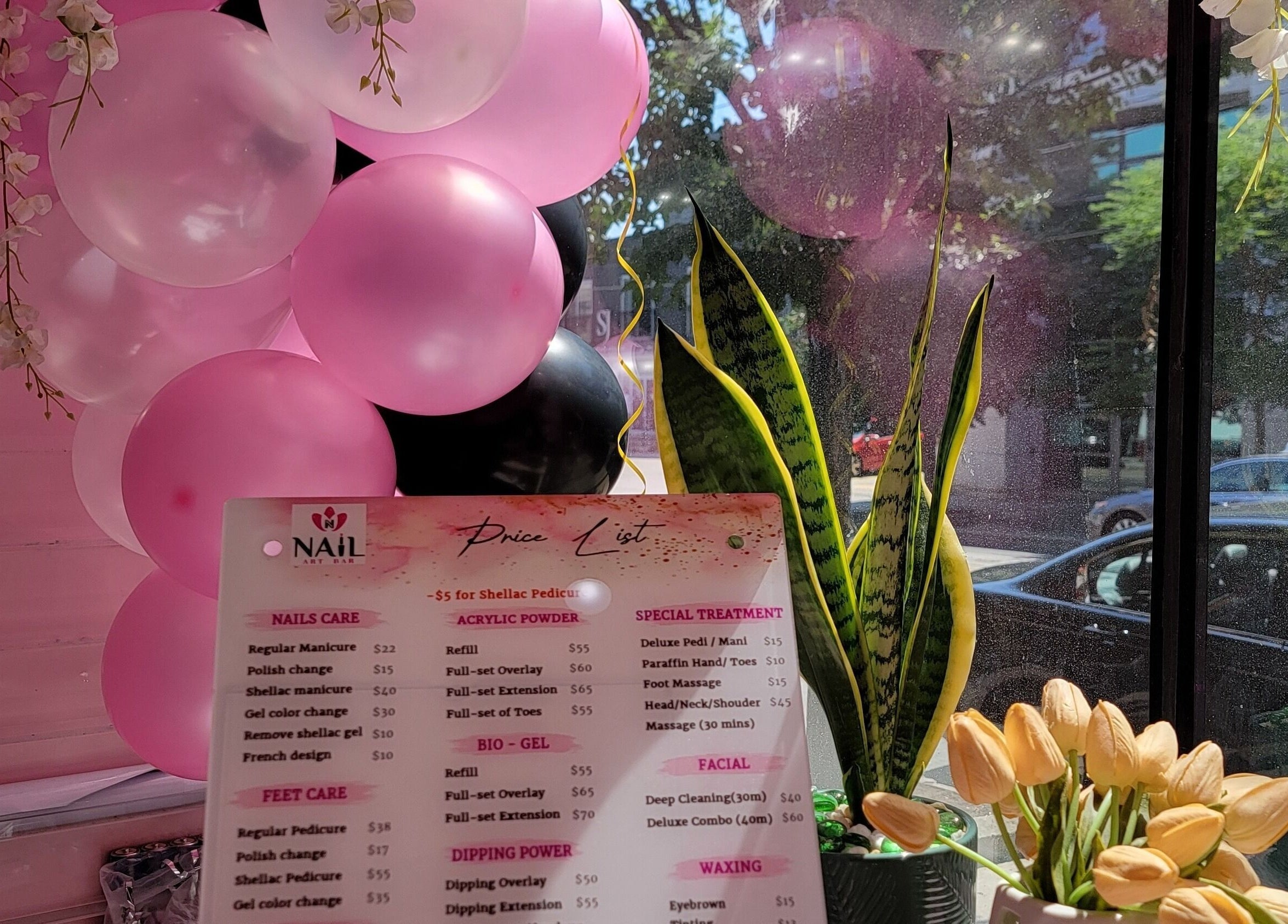 Nail Art Bar price list with pink balloons and plants at Toronto, Ontario, CA venue.
