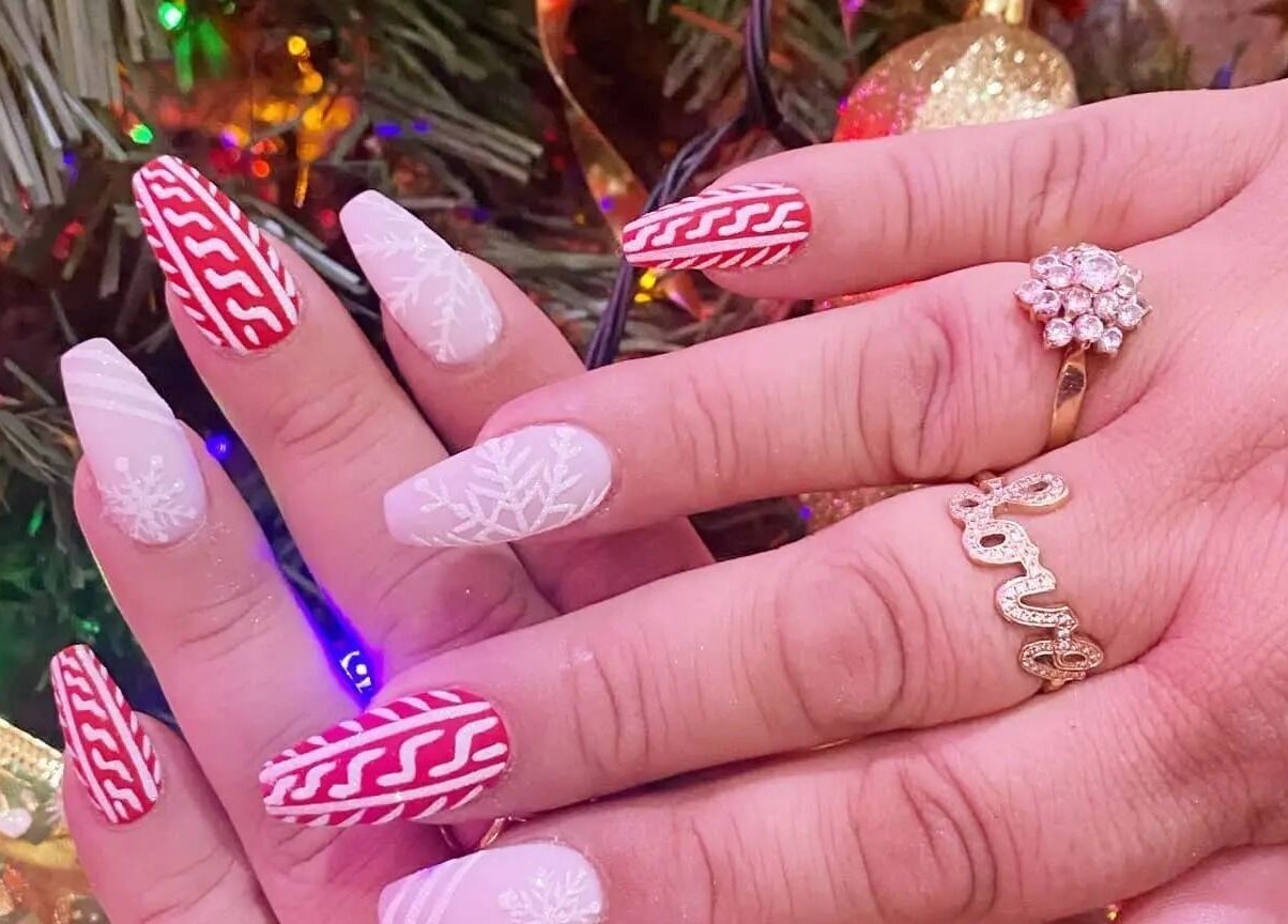 Festive nail art with red and white patterns at Nail Art Bar, Toronto, Ontario, CA.