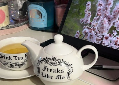 Teapot and cup set at The Honest Beauty Collective, Guildford, New South Wales, AU, with floral backdrop.