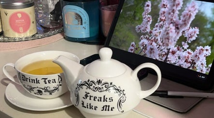 Teapot and cup set at The Honest Beauty Collective, Guildford, New South Wales, AU, with floral backdrop.