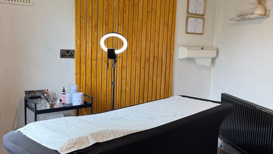 Tranquil treatment room at Studio No. 9 in Hucknall, England, GB, featuring spa bed and elegant decor.