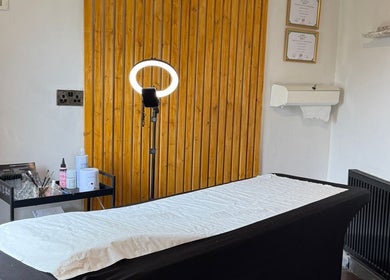 Tranquil treatment room at Studio No. 9 in Hucknall, England, GB, featuring spa bed and elegant decor.