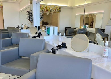 Chic salon interior at Laurens d'Auray, Grays, England, GB with elegant chairs and flower decor.