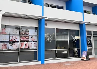 Exterior of Aim to be u beauty & massage in Perth, Western Australia, AU with colorful signage.