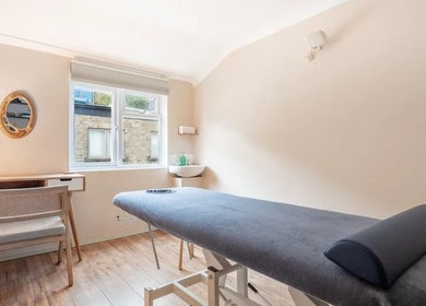 Massage room at SOLUNA Holistic Massage Therapy in London, England, GB featuring a comfortable massage table.