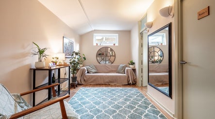 Relaxing seating area at SOLUNA Holistic Massage Therapy, London, England, GB, featuring cozy decor and natural light.