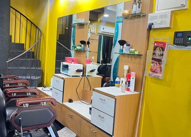 Modern salon chair and vibrant yellow wall at Lubys, Chennai, Tamil Nadu, IN reflecting a stylish ambiance.