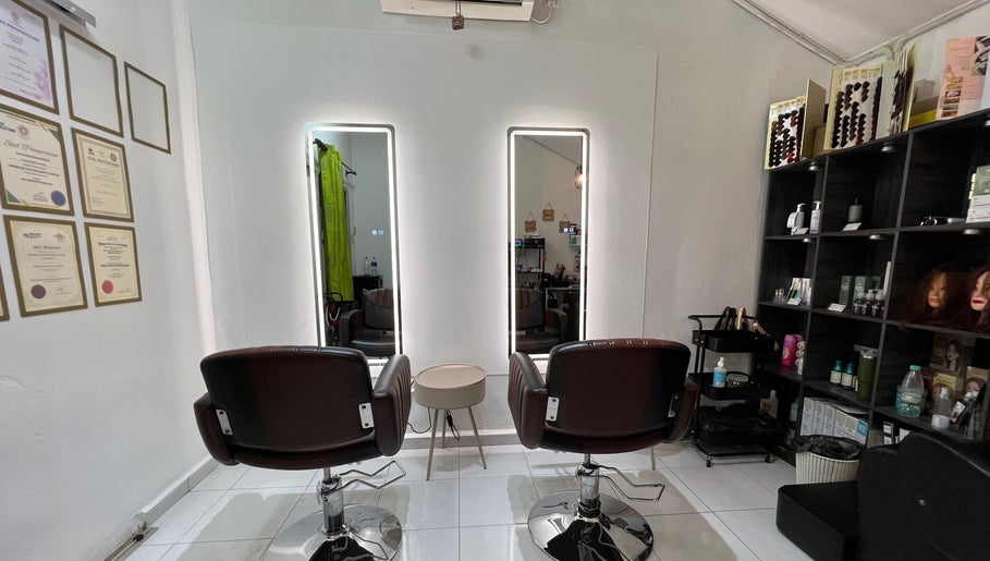 Elegant interior of FB Beauty Hair Salon in Langgar, Kedah, MY featuring modern styling chairs and product displays.