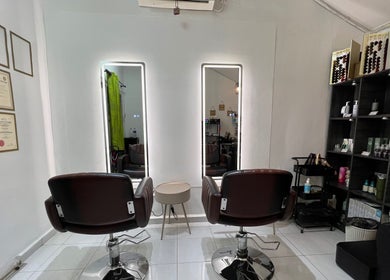 Elegant interior of FB Beauty Hair Salon in Langgar, Kedah, MY featuring modern styling chairs and product displays.