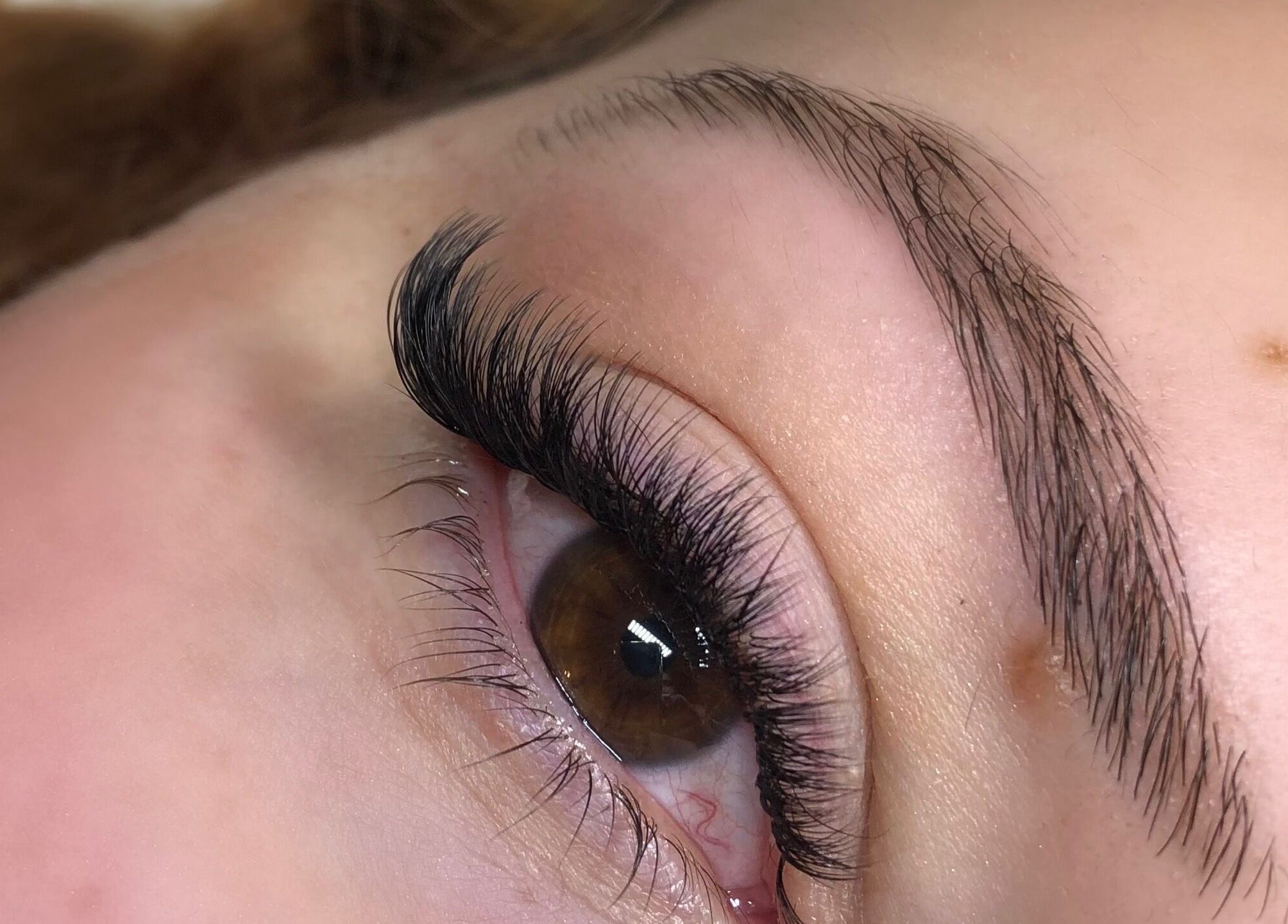 Close-up of enhanced lashes at Hennylash, London, England, GB showcasing meticulous beauty treatment.